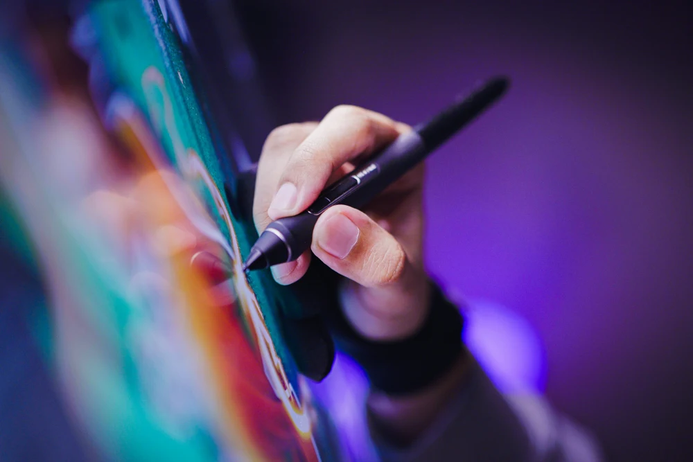 A digital artist using a stylus on a tablet